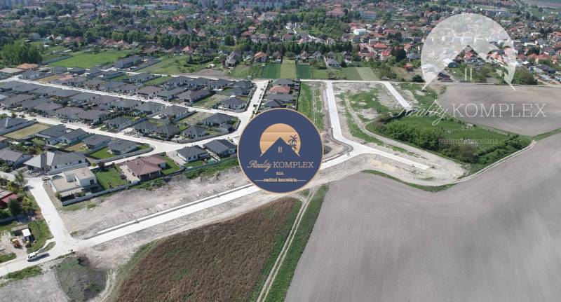 Aerial view of plots - housing in Veľký Meder with new buildings and surrounding landscape.