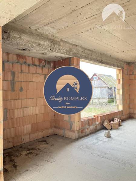 Unfinished interior of a family house with raw brick walls in Zlatná na Ostrove.