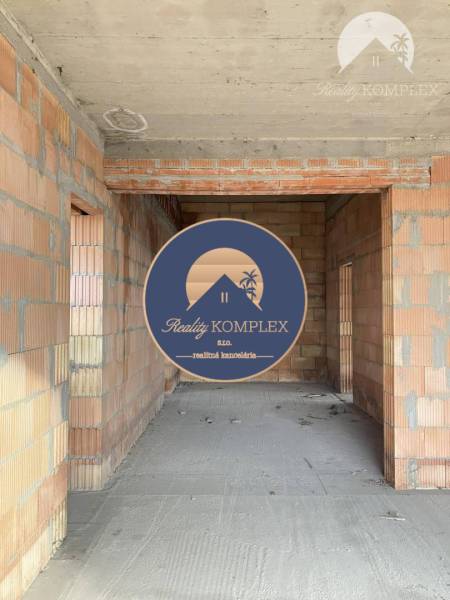 The interior construction of a family house with bare brick walls.