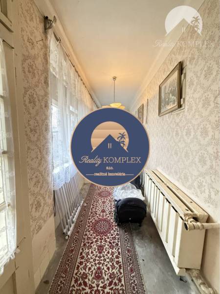 A hallway in a family house with carpet and wallpaper, suitable for Strekov.
