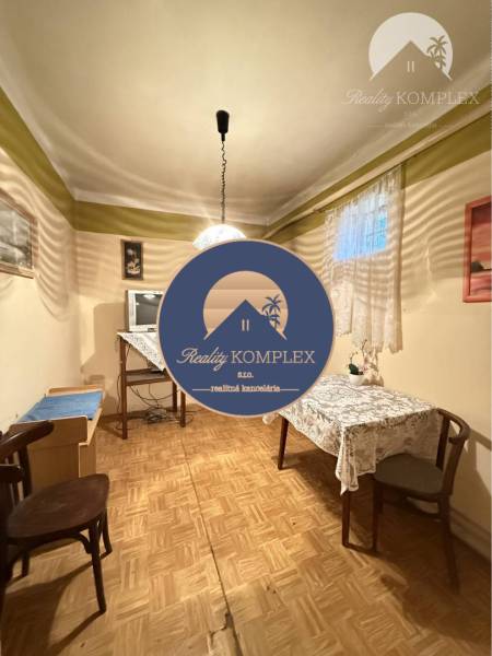 A room in a family house with a wooden decor floor and simple furnishings.