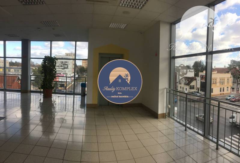 Interior of a commercial space with large windows and ceramic tiles.