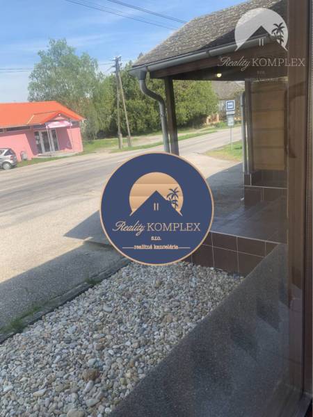Exterior in Chotín on Hlavná Street with warehouses and halls and gravel decor.