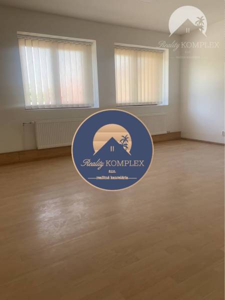 Interior with light walls, wood-patterned flooring, blinds on the windows.