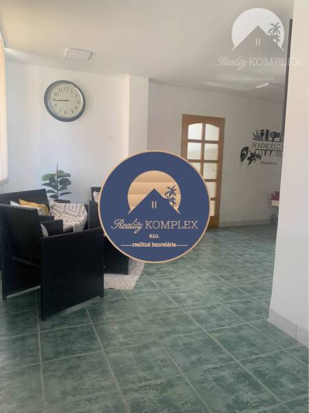 Interior with a table, chairs, clock, and tiled floor, warehouses and halls.