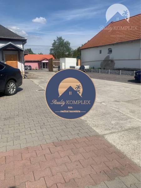 Asphalt road and buildings on Hlavná Street in Chotín, area Warehouses and Halls.