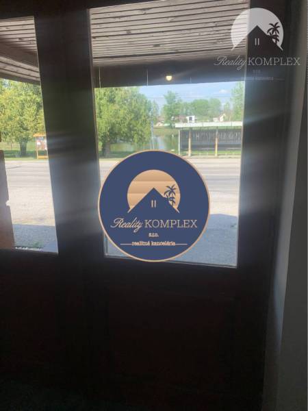 Exit from the warehouse and halls on Main Street in Chotín with a view of the surroundings.