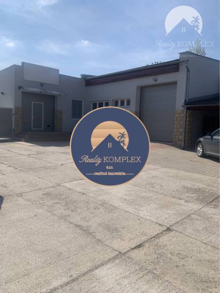 Warehouses and halls on Hlavná Street in Chotín, concrete area and garage doors.