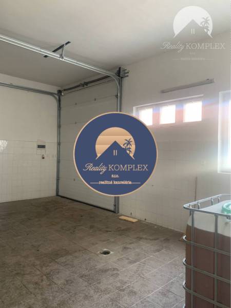 Interior of warehouses and halls with a garage door and lights on the wall.