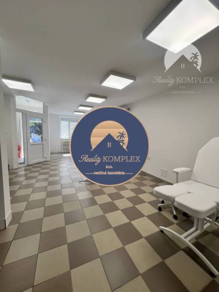 Interior of commercial spaces with tiles, a white sofa, and large windows.