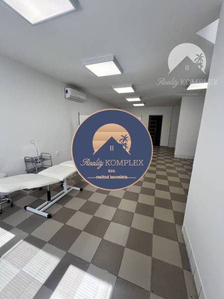 Office spaces with tiles and ceiling lights.