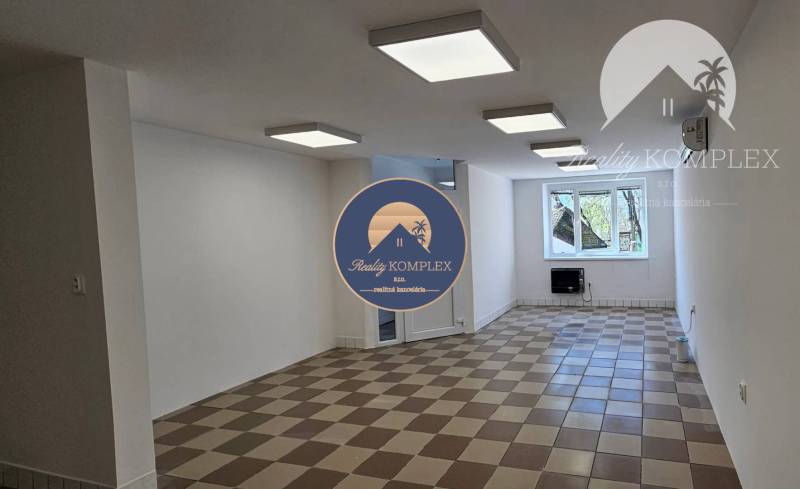 Commercial premises with ceramic flooring, white walls, and ceiling lights.