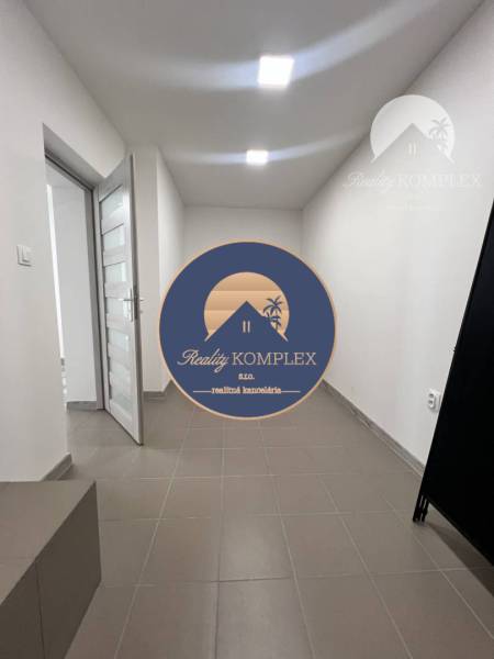 Interior of commercial spaces with tiled floors and white walls.