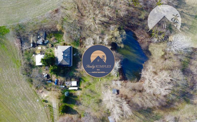 Aerial view of a plot in Dedina Mládeže with a garden and a pond, ideal for living.