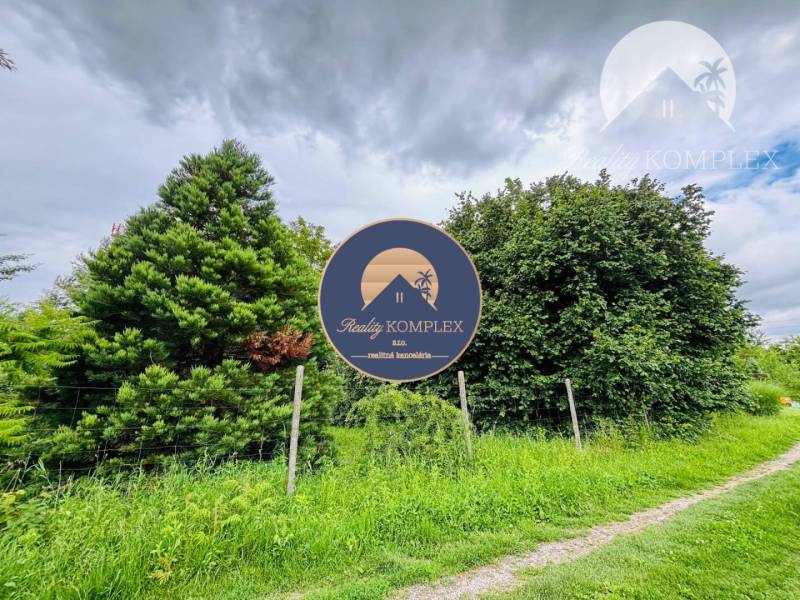 Greenery and a tree in the background, ideal for living in Dedina Mládeže.