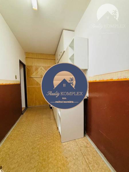 Hallway in a 3-room apartment, light walls, wooden paneling, built-in cabinets.