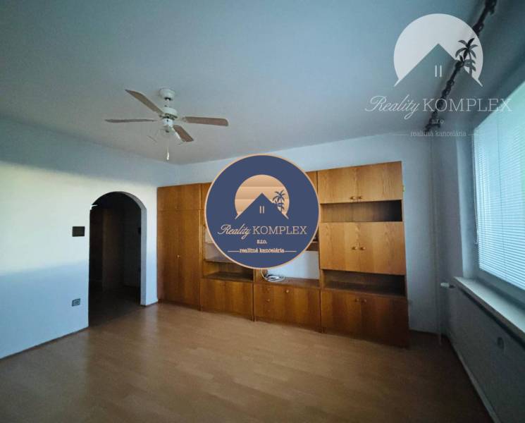 A room in a 3-bedroom apartment with a bright interior and a door leading to the hallway.
