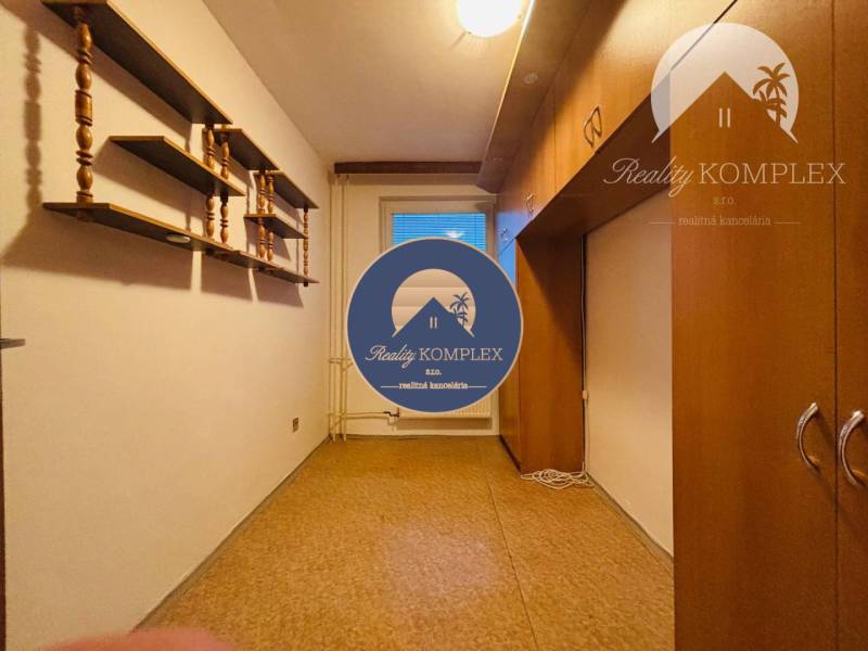 A narrow space in a 3-room apartment with shelves and a built-in wardrobe.