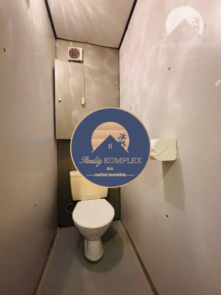 A bathroom in a 3-room apartment, simple interior with gray walls and floor.