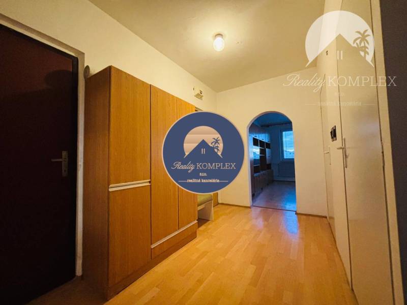 A hallway in a 3-room apartment with wooden flooring and built-in wardrobes.