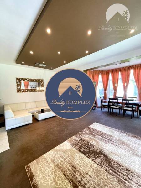 Living room with carpet decor, sofa, and dining table in a family house.