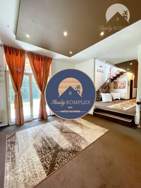 Elegant interior of a family house with a decorative carpet and staircase.
