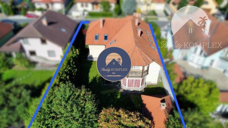 A family house in Dunajská Streda with a red roof and an enclosed garden.