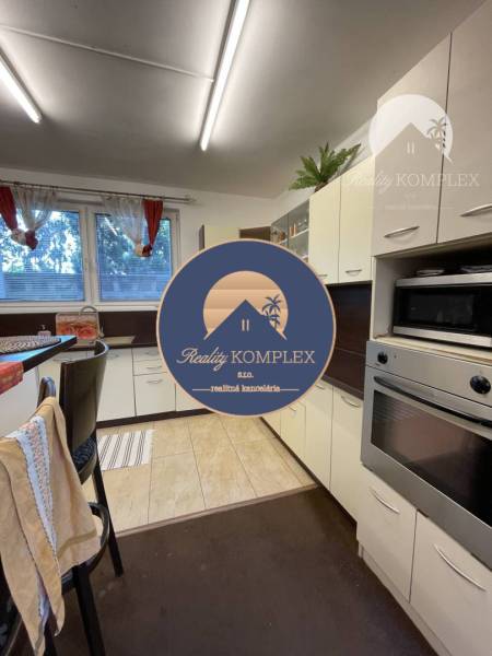 A kitchen in a family house with a kitchen unit and a bar counter, interior in white color.