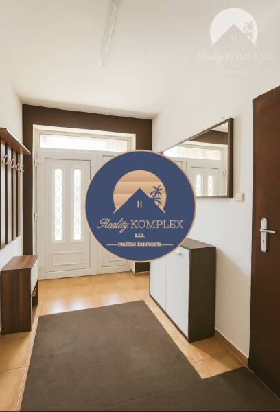 The entrance hall in the family house with white doors and orange tiles.