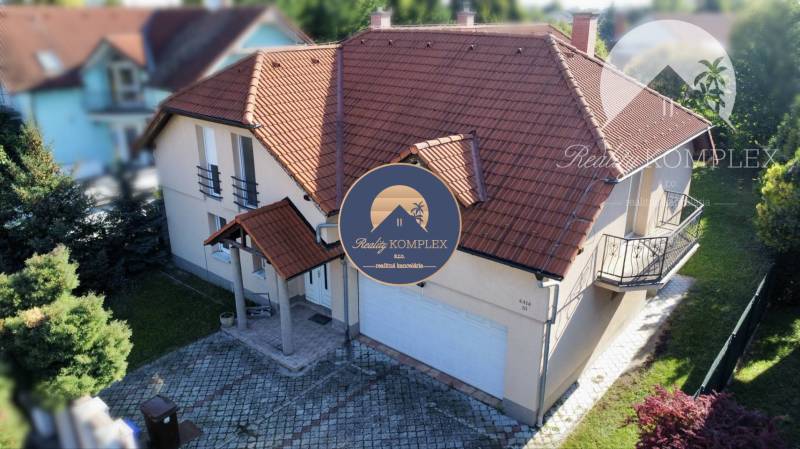A family house in Dunajská Streda with a red roof, a small balcony, and a garage.