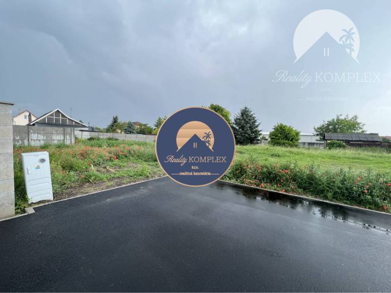 A residential plot in Šamorín on Bučuháza with an asphalt access road.