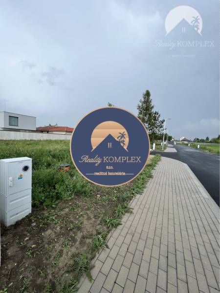 Sidewalk on Bučuháza Street, Šamorín, Land - residential, with open green space.