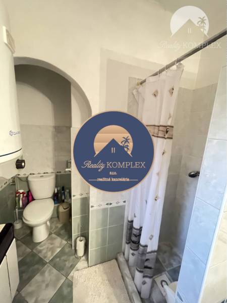 Bathroom in a family house with a toilet and a shower corner.