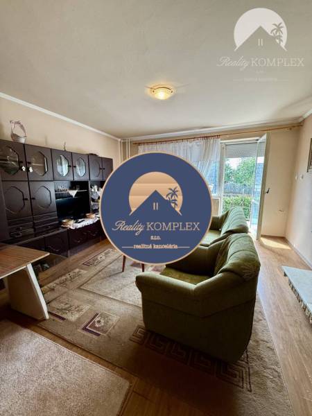 Living room in a family house with a sofa and wooden decor flooring.