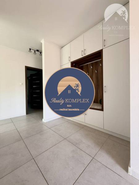 Interior of a family house with light tiles and built-in wardrobes.