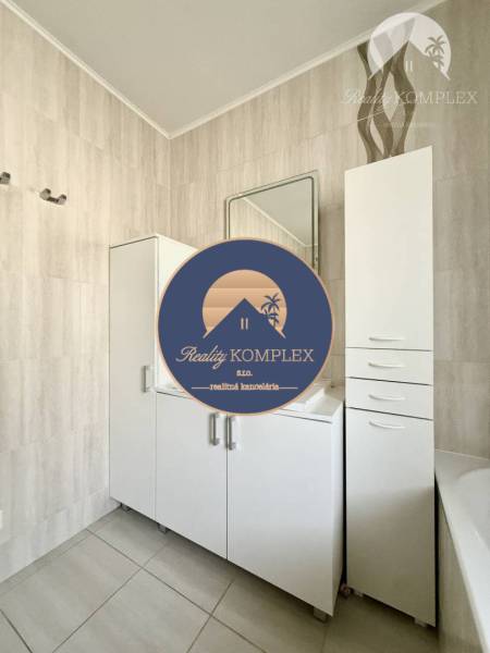 Bathroom in a family house with light furniture and a mirror.