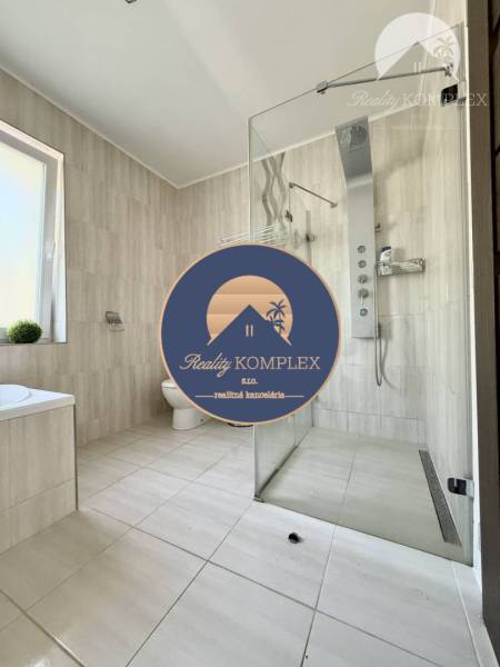 A bathroom in a family house with a spacious shower and modern equipment.