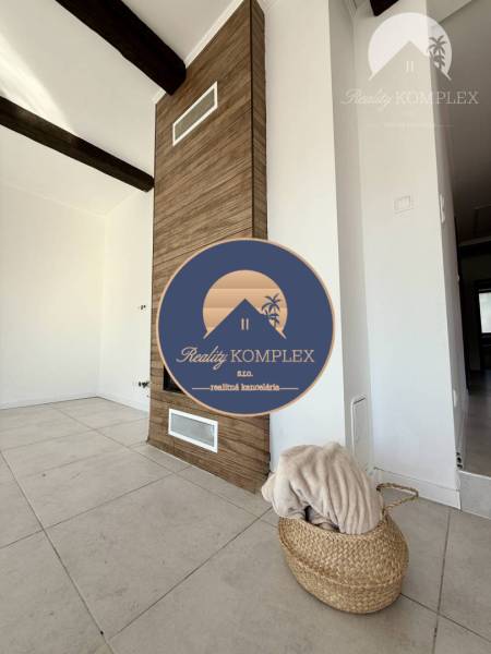 The interior of a family house with a wooden decor floor and modern design elements.
