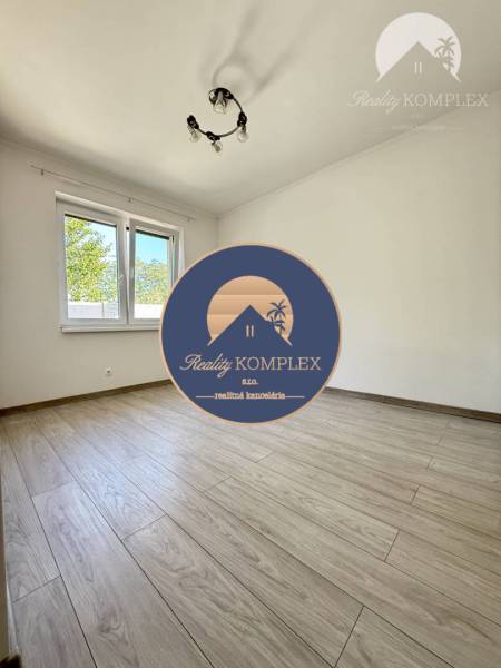 A spacious room in a family house with a wooden decor floor.