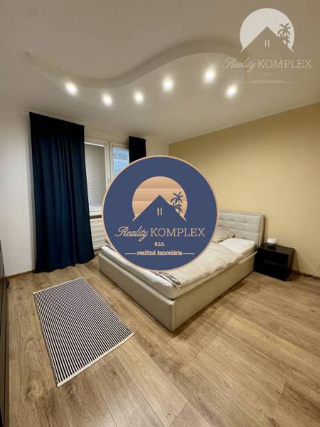 A bedroom with stylish lighting and a bed in a 4-room apartment.