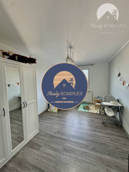 Children's room with toys, wardrobe, and dining chair in a 4-room apartment.