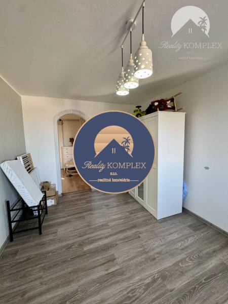 Interior of a 4-room apartment, laminate flooring, white furniture, pendant lights.