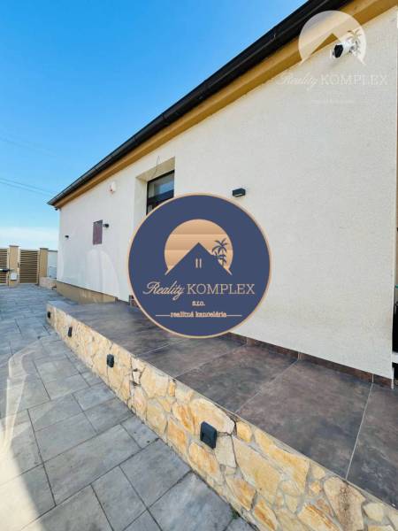A family house with an elegant stone staircase, a minimalist facade, and modern exterior lights.