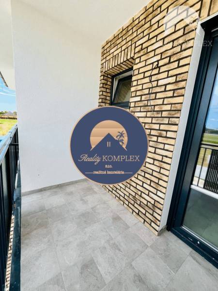 The balcony of a 3-room apartment in Veľký Meder with brick cladding and modern tiles.