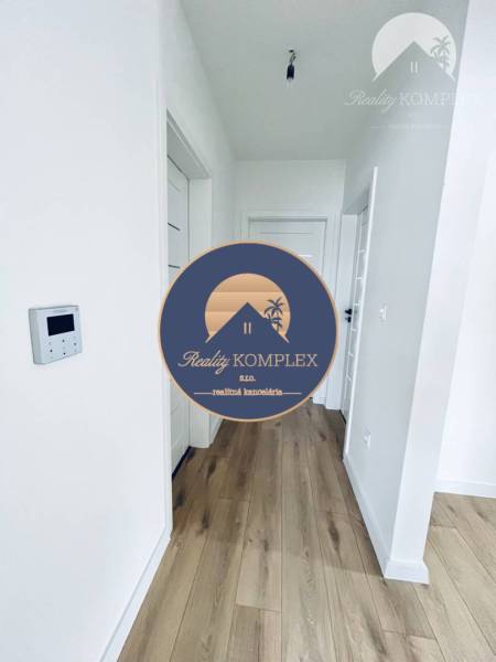 Interior of a family house with a wooden decor floor and white doors.
