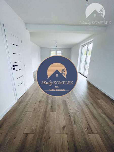 Interior of a family house with white walls and a wooden decor floor.