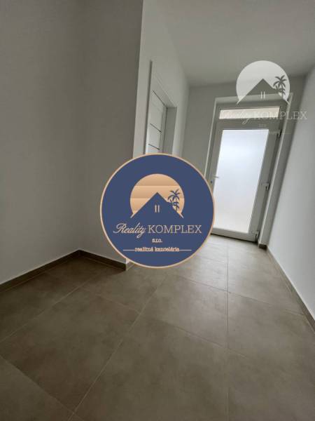 View of the entrance hallway in a family house with tiles in Topoľníky.