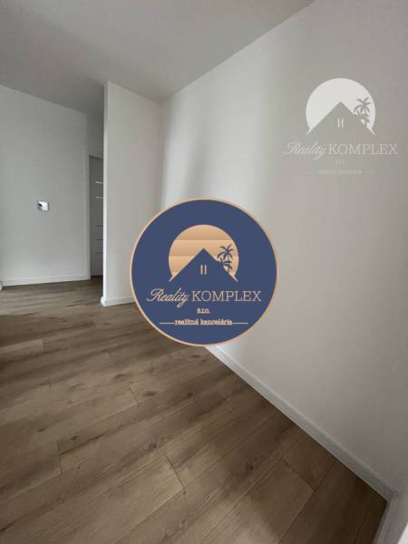 Interior of a family house with a wooden decor floor and white walls.