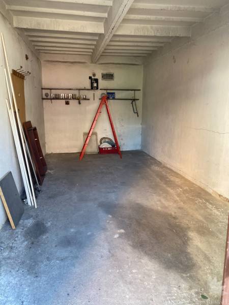 Garages on Čmelíkova Street, Bratislava - Ružinov with a ladder and shelves.