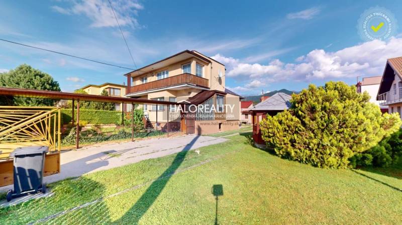 A family house in Krasňany with a garage, garden, and wooden facade decor.